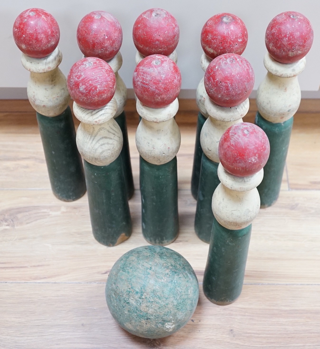A set of turned wooden skittles and ball